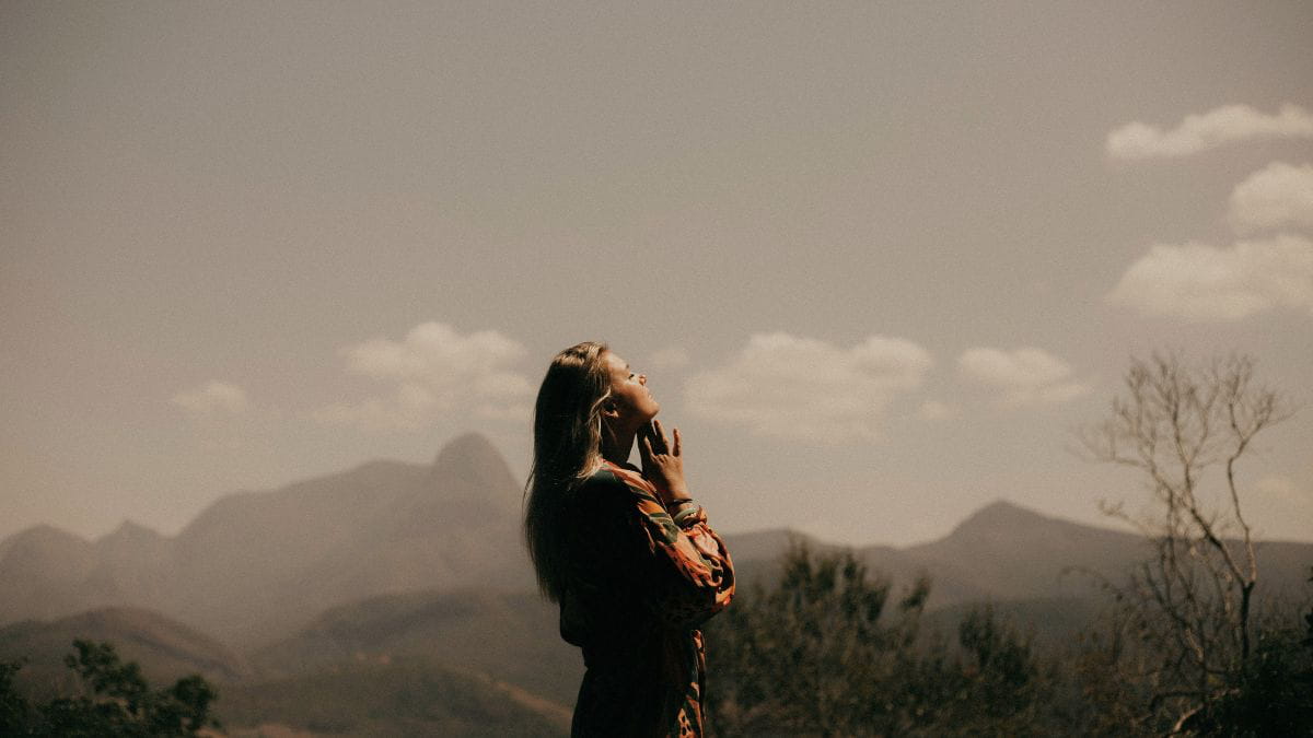 Woman breathing in fresh air in a calm and peaceful environment.