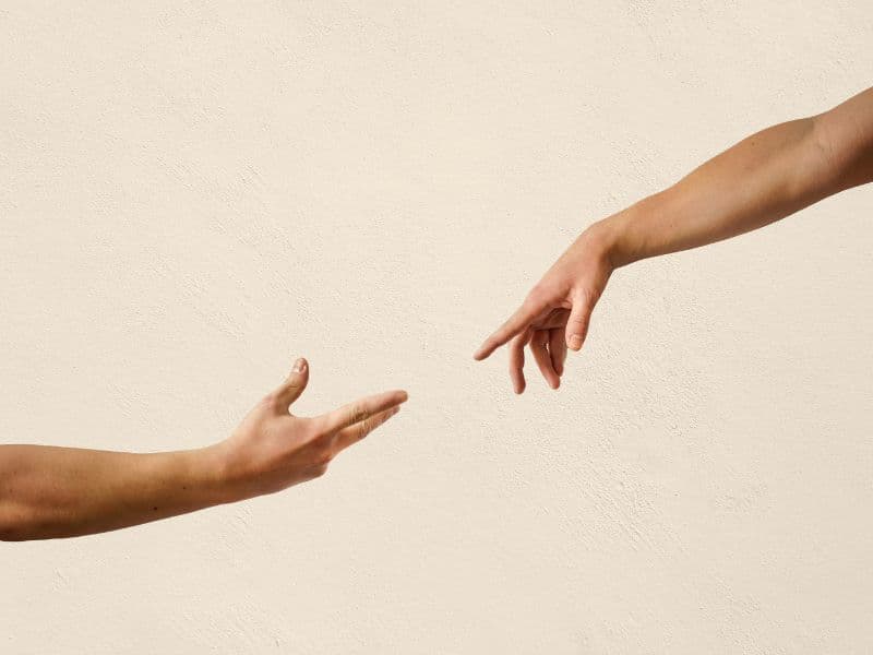 Hands reaching for each other representing the possibilities of support that therapy brings.