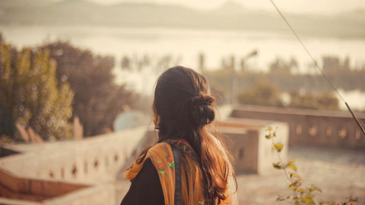 South Asian woman looking at peaceful scenery.
