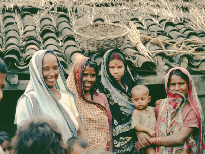 South Asian women smiling together representing a close knit community.