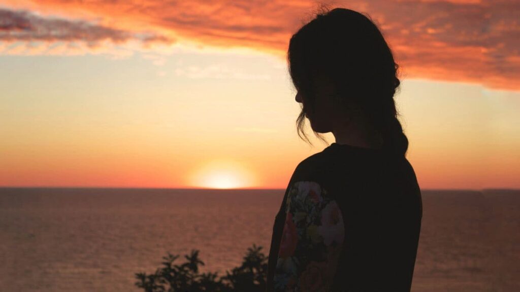 Calm sunset representing reflection and transition to a stronger self.