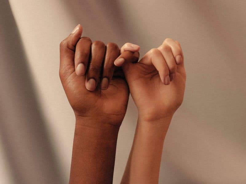 Intertwining fingers representing togetherness during healing.