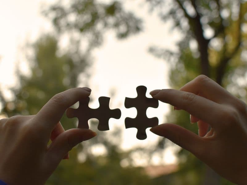 Two puzzle pieces that perfectly fit together representing the idea that survivors of abuse can never be broken.