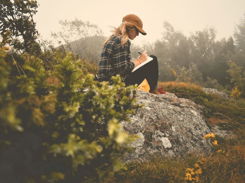 Woman journaling to process emotional healing.