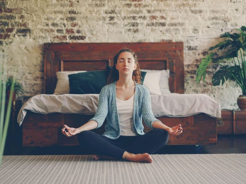 Girl meditating representing self-care as a healing method.