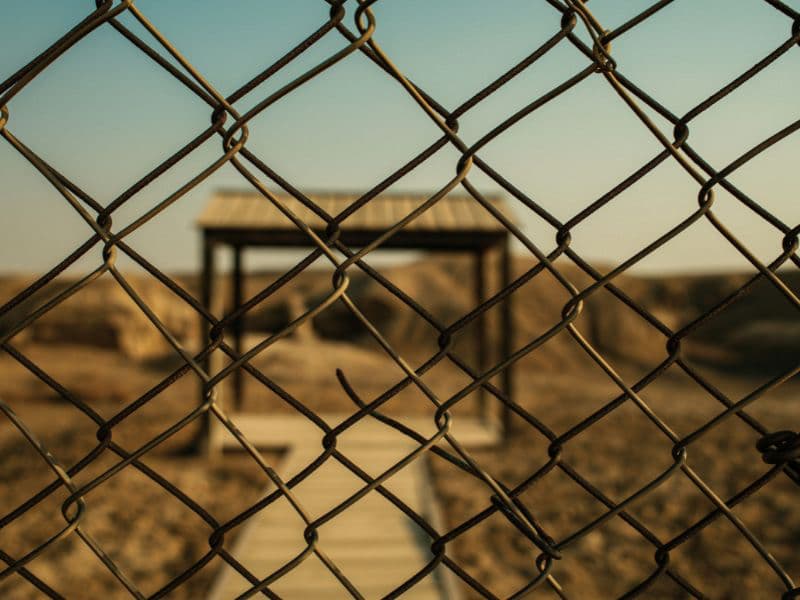Fence blocking a gazebo representing boundaries protecting survivors from harm.