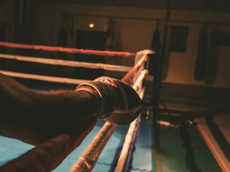 Man wearing boxing glove who appears to be ready to fight, representing fighting as a survival mechanism.
