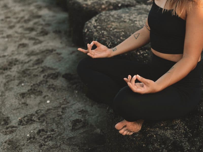 Person practicing the 5-4-3-2-1 grounding technique to stay present during anxiety.