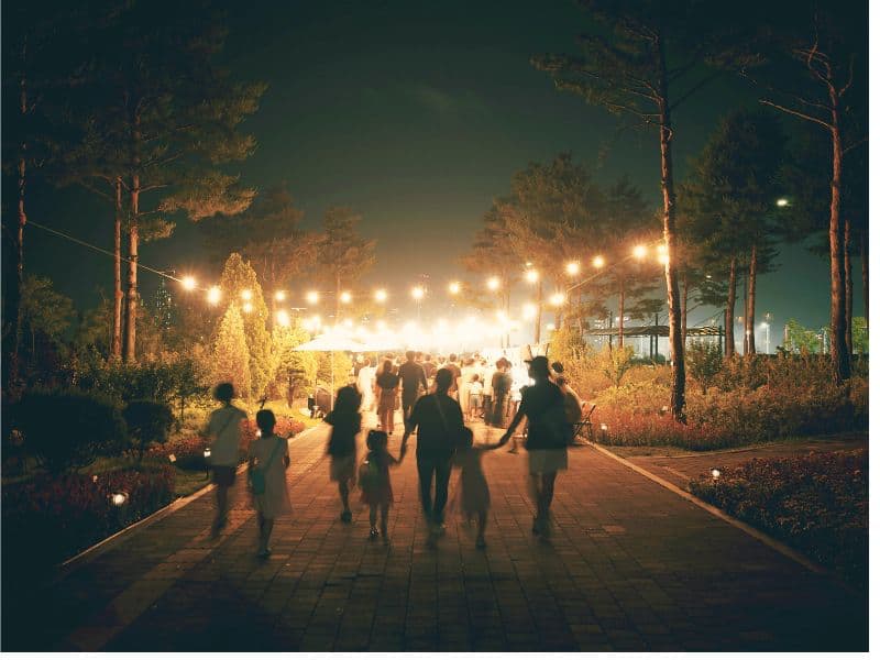 Family holding hands and walking together at night, symbolizing support, connection, and healing from mental health stigma.