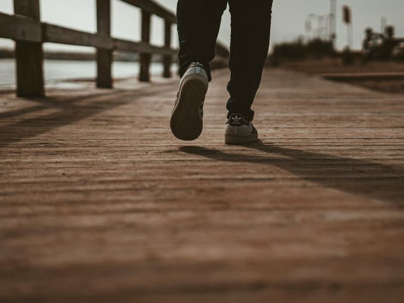 Person walking along a harbour as a physical grounding exercise for anxiety.