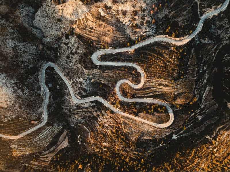 Aerial view of a winding road with many curves, illustrating that healing is not a linear journey.